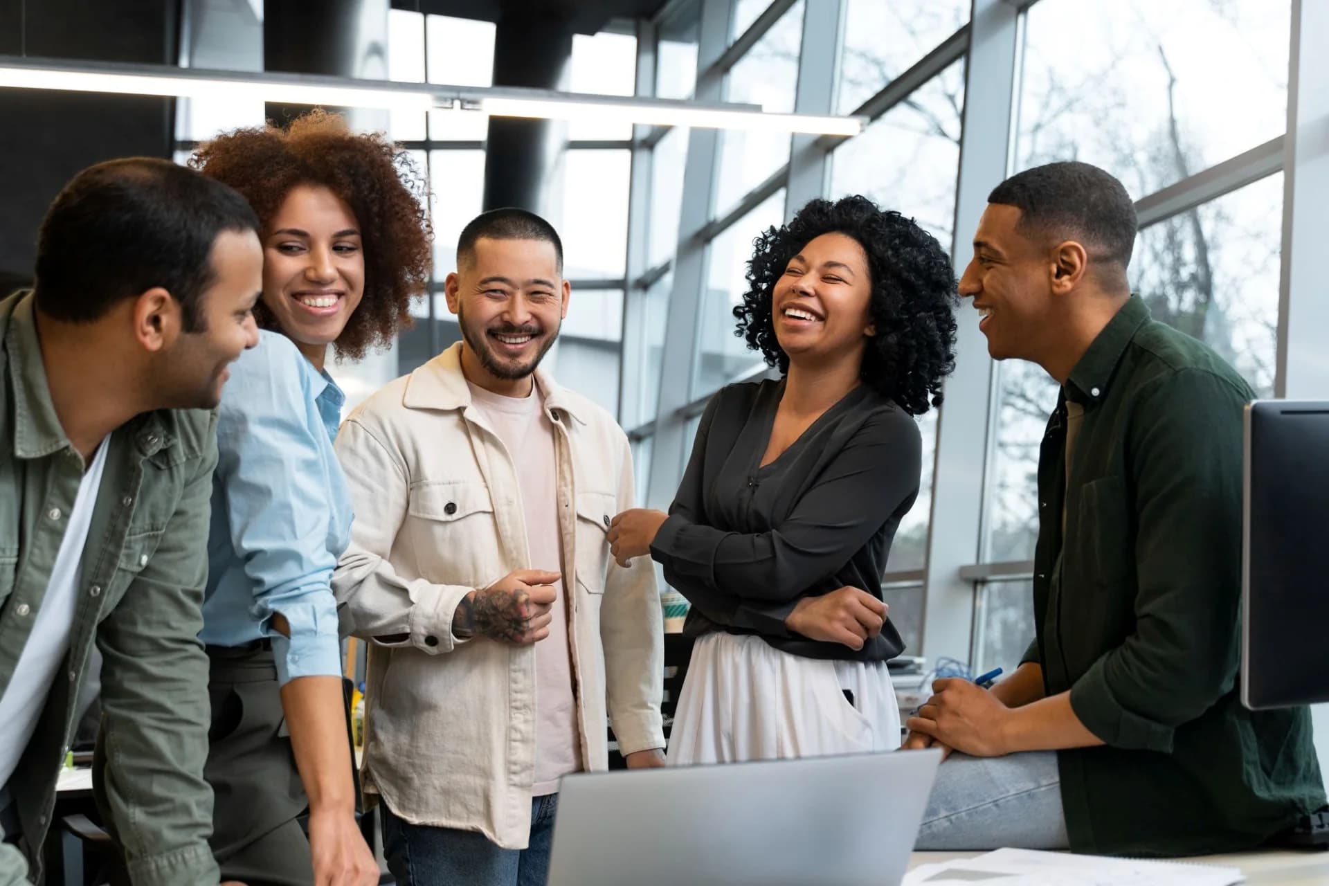 A smiling team celebrating together in an office