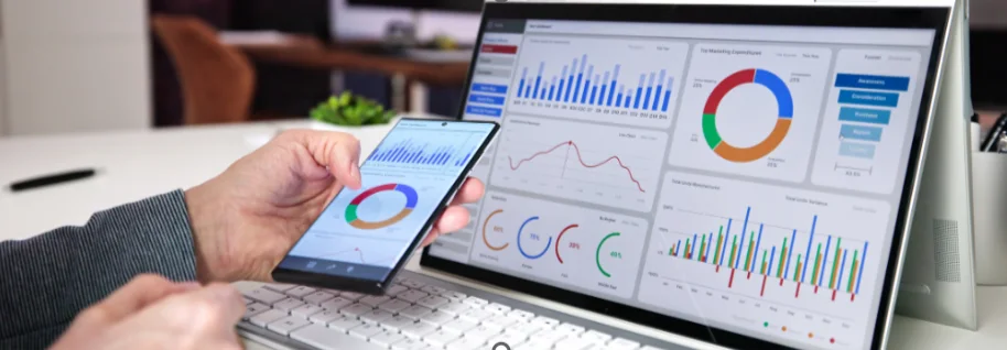 A laptop and tablet showing business analytics charts